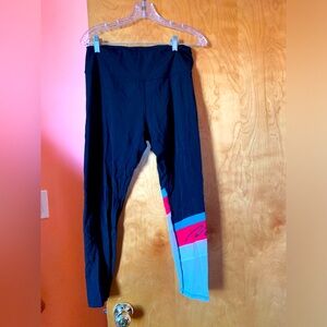 Motif sports leggings. With red, green, light gray graphic on one leg